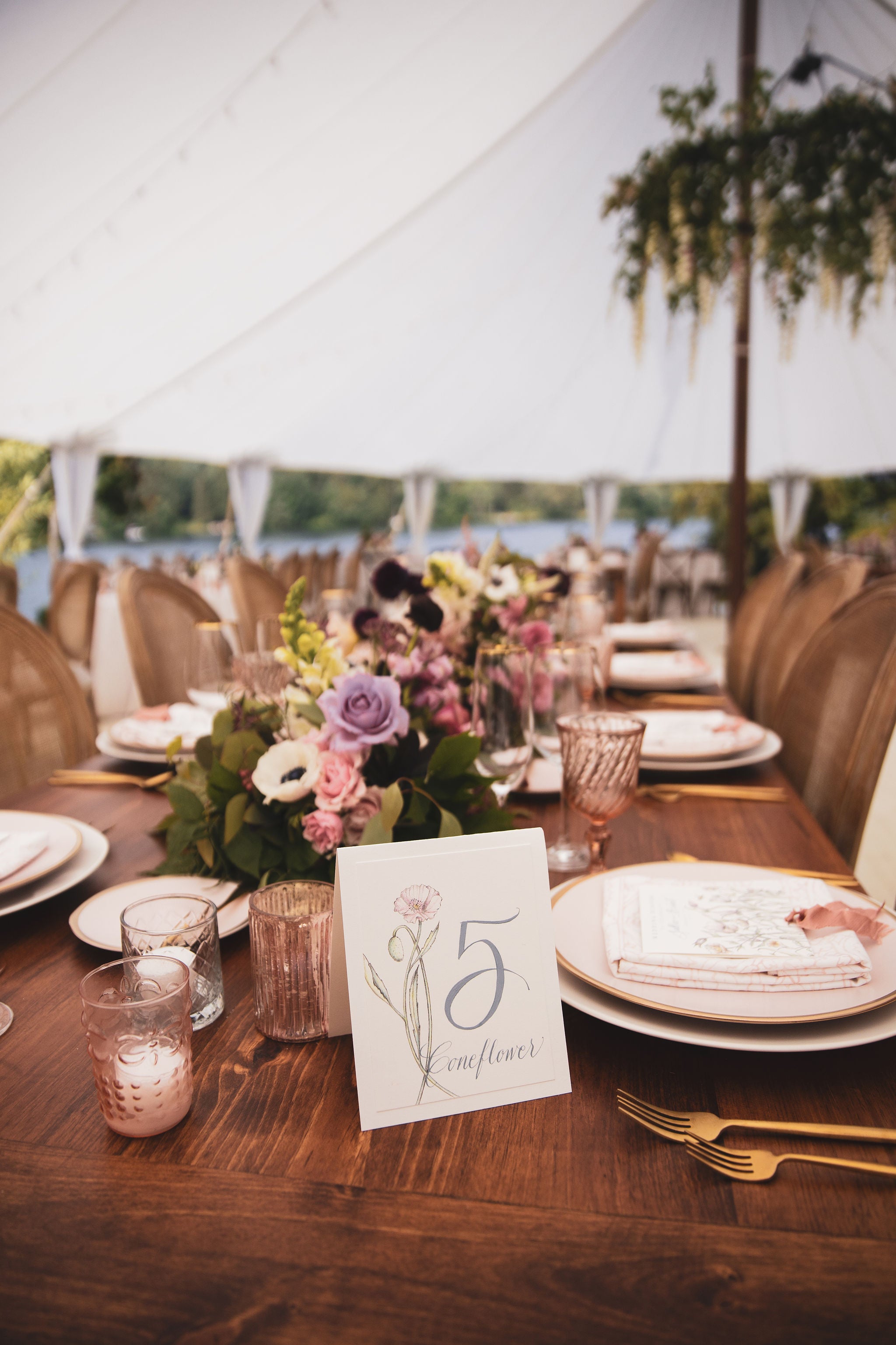 long farm table with colorful centerpieces down the middle