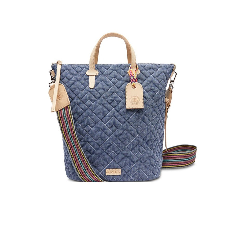 Abby Sling | Consuela | A Denim blue quilted bag with a multi colored crossbody strap and diego leather sling strap.