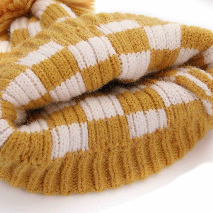 Accity | Knit yellow checkered beanie with a pom pom.