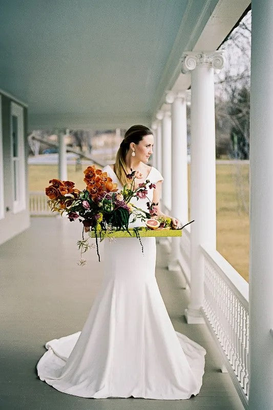 tray of florals held by a bride at Inns of aurora