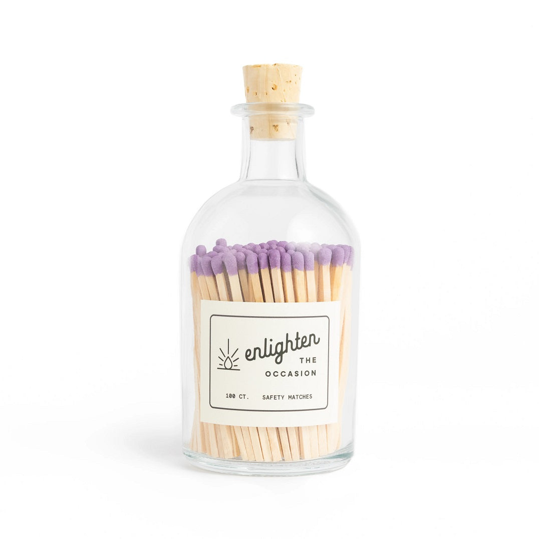 Apothecary Jar with Iced Lavender Matchsticks | A glass bottle with a cork. Simple white label that reads "enlighten the occasion, 100ct. safety matches. Long stick lavender colored matches.