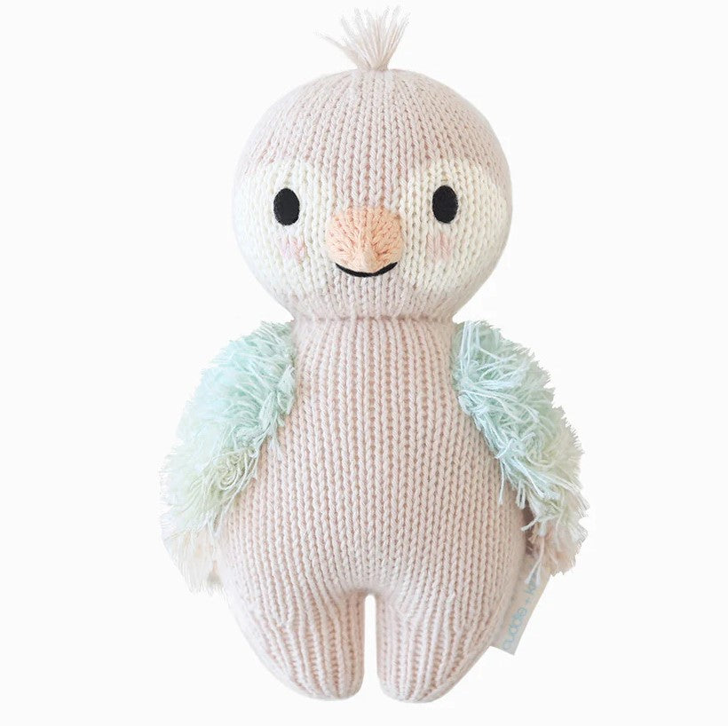 Cuddle + Kind | Baby Parrot plush in the color mauve with blue and green wings.