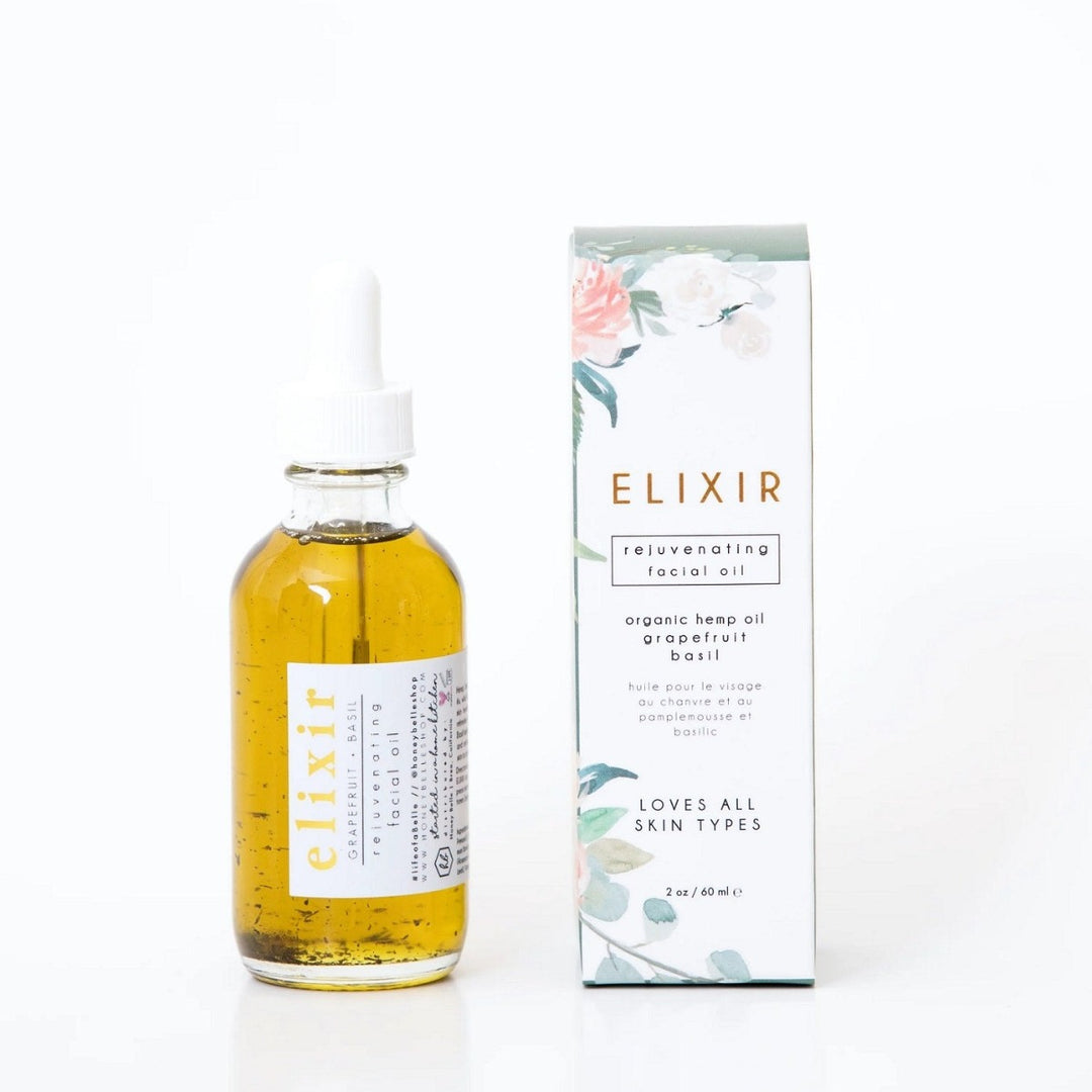 Elixir Facial Oil | Honey Belle | Clean white packaging and aesthetic floral pattern. Comes in a glass bottle with a dropper.