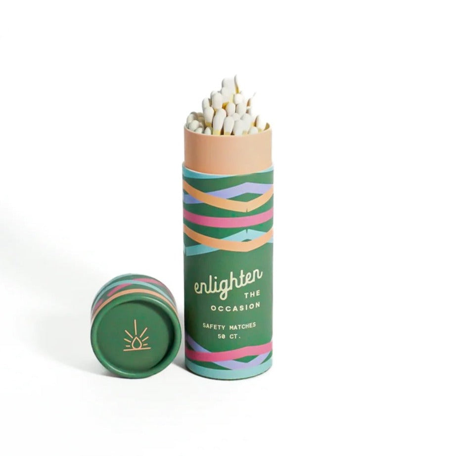 Green Sea Burst Match Tube | A green tube with colorful lines and matches sticking out of the top. Text reads "Enlighten the occasion, safety matches, 50 ct.".