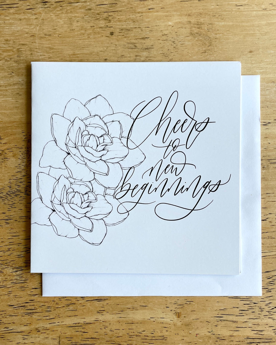 Black and White square card showcasing illustrations of flowers and "Cheers to new beginnings" message. 