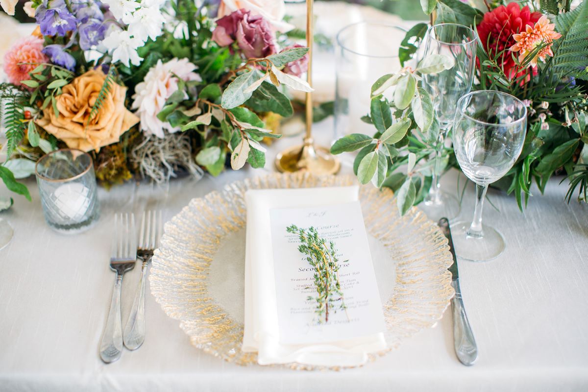 Thyme place setting on a styled table with gold charger and spring flowers