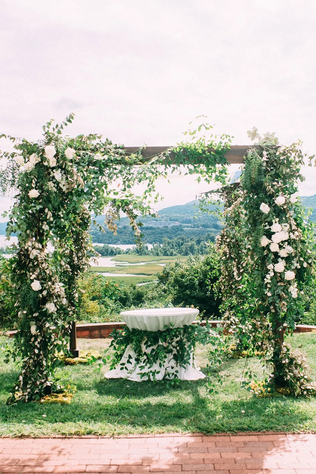 chuppah on the hudson river covered in vines and flowers
