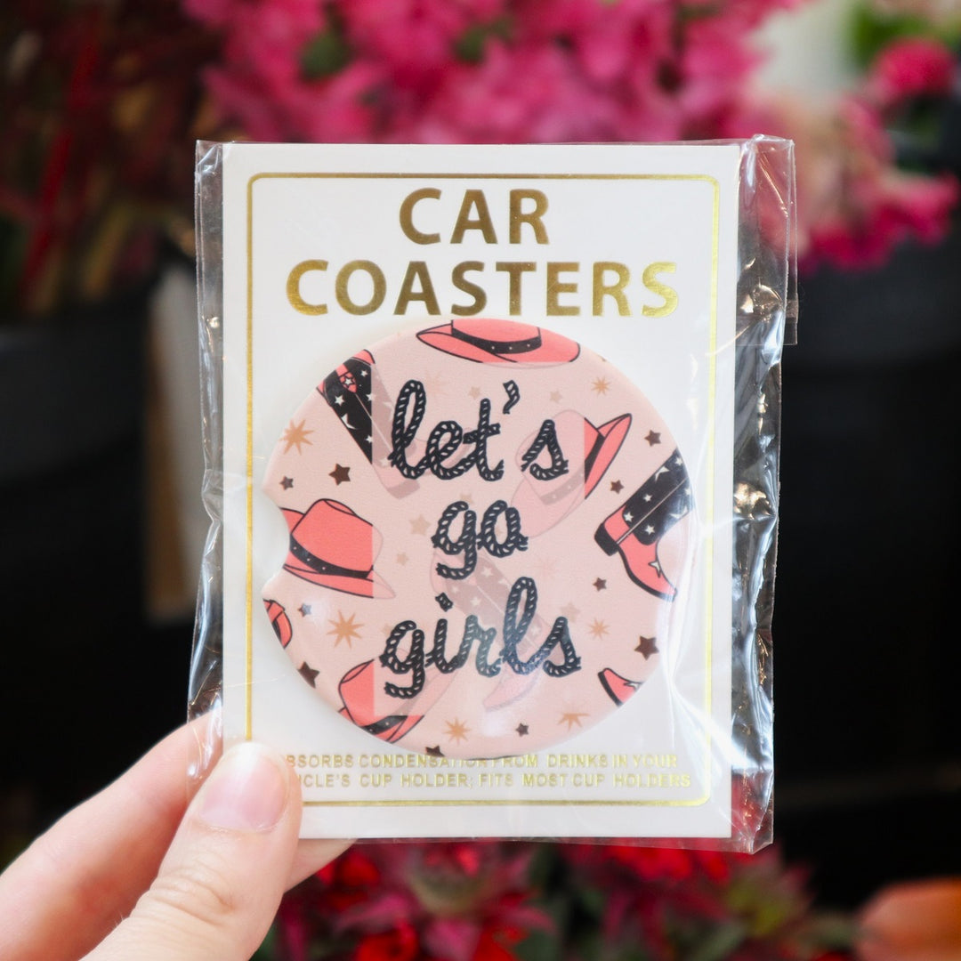 Assorted Car Coasters | Let's Go Girls | A cowgirl themed coaster with stars, pink cowgirl hats, and matching boots. Text is "lasso rope" themed and reads "Let's Go Girls".