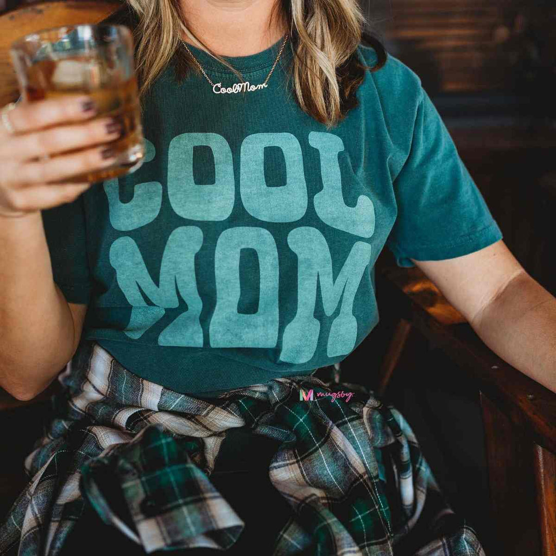 Mugsby | "Cool Mom" Shirt | A teal blue shirt with light teal text.