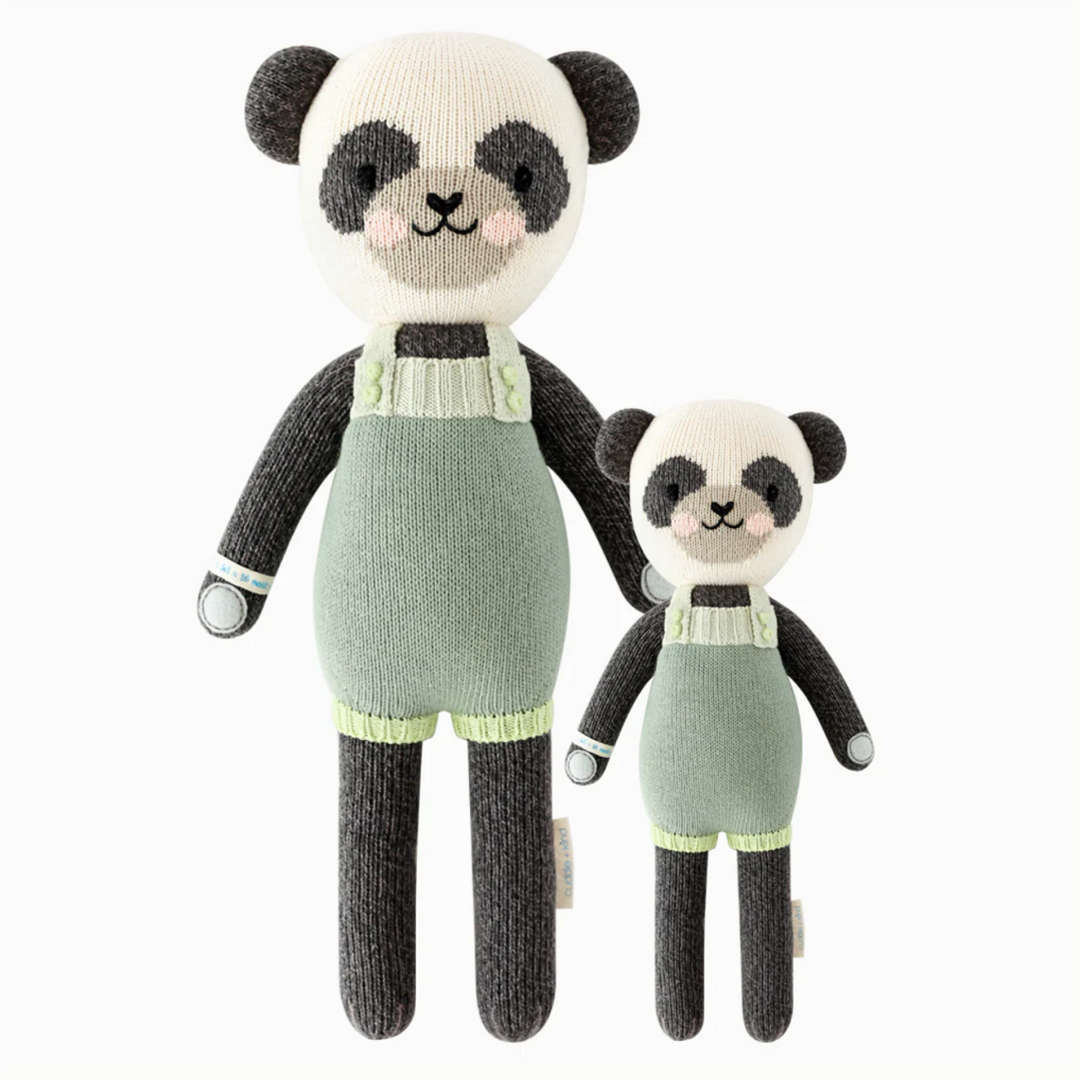 Paxton the Panda | Cuddle + Kind | A black and white panda with pink cheeks and green overalls. Two sizes pictured, 20" and 13".