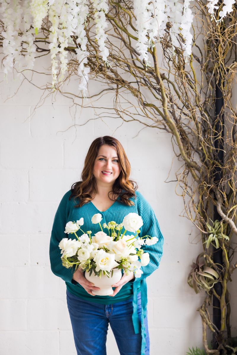 Headshot of aimee holding flowers