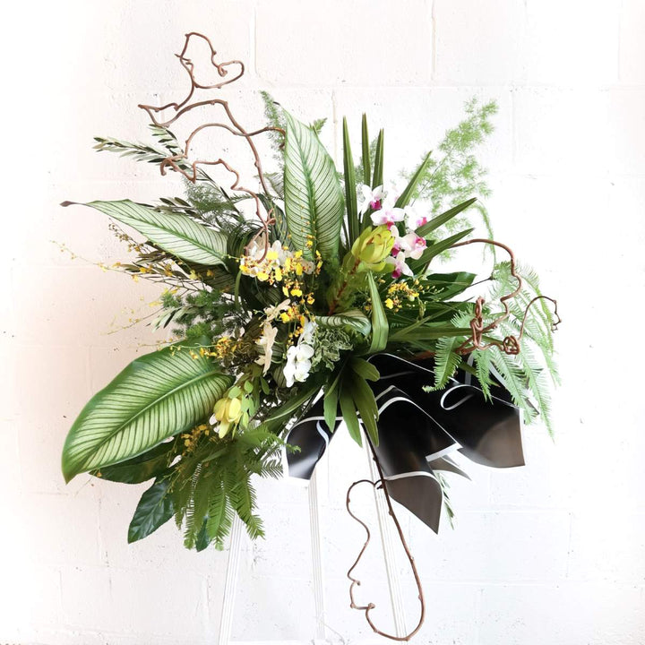 Stacy K Floral | natural standing spray, greenery with orchids. Sympathy