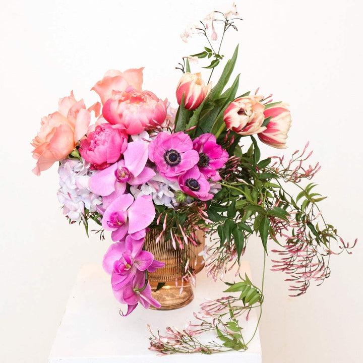 Stacy K Floral | Wild Blush Symphony | A lush arrangement full of pinks and greens. See roses, peonies, anemone, orchids, double tulips, and hydrangea.