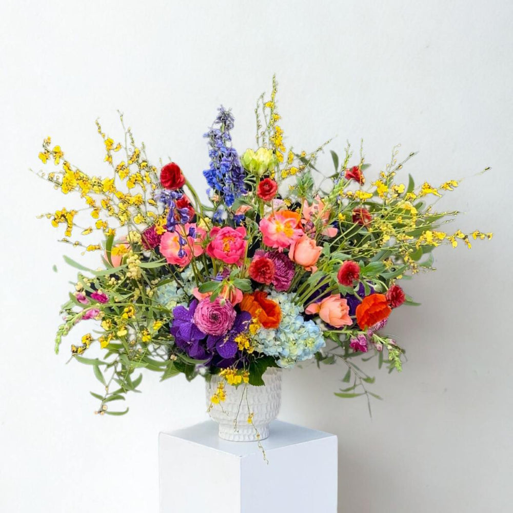 Stacy K Floral | Wild Symphony | A bright and full arrangement with orchids, peonies, roses, hydrangea, and more.