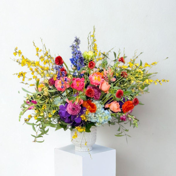 Stacy K Floral | Wild Symphony | A bright and full arrangement with orchids, peonies, roses, hydrangea, and more.