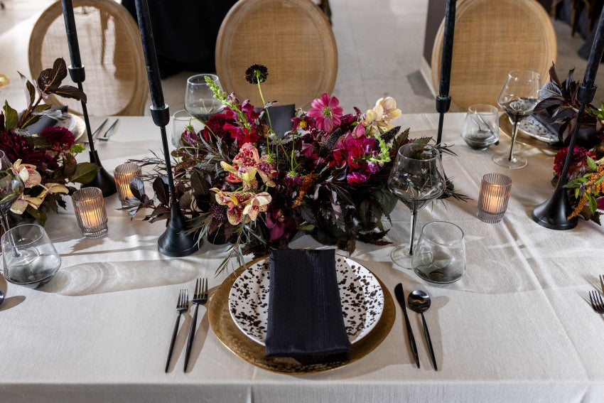 The Duke | A floral arrangement with pink, yellow, black, and green.
