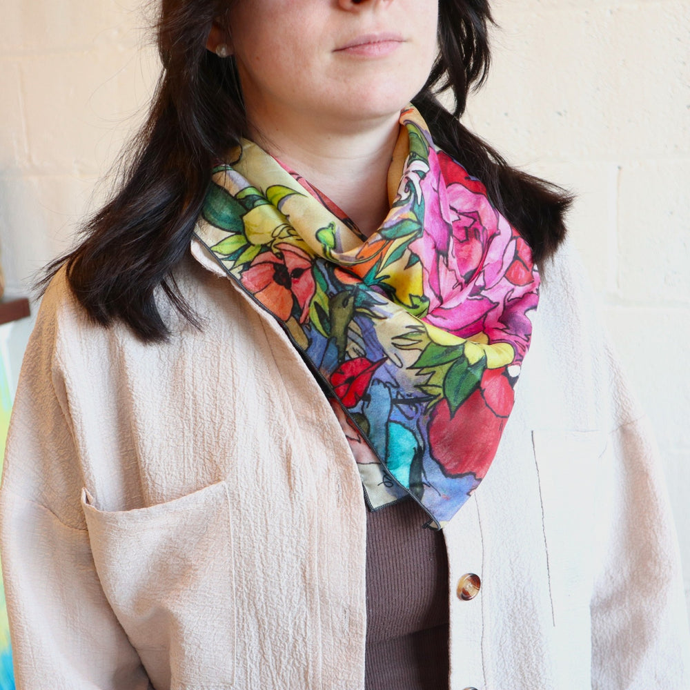 handpainted silk scarf by andrea durfee, on a model with dark hair