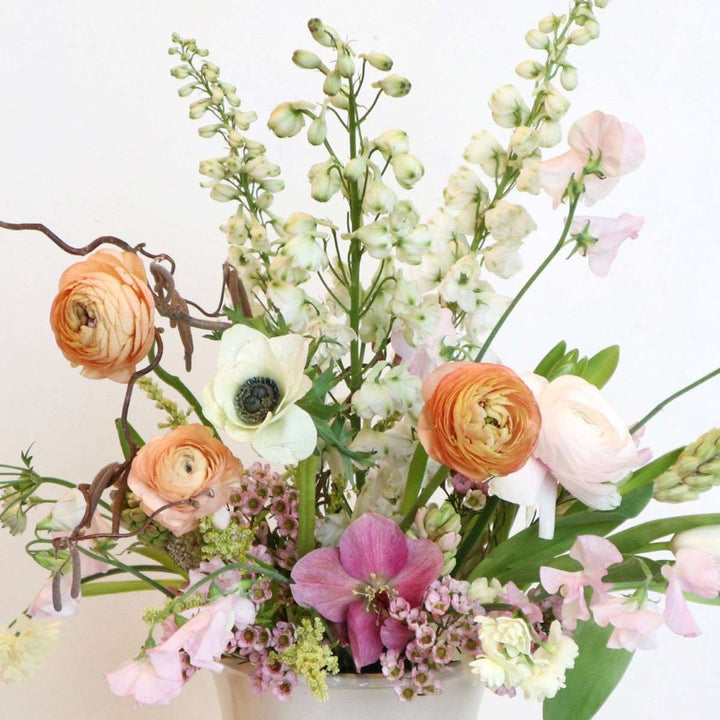 Close up on a fresh floral arrangement with ranunculus, and accent florals.