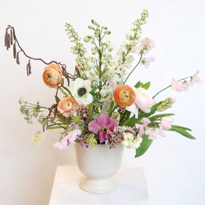 arrangement with ranunculus, sweet pea, delphinium, anemone, hellebores, Astrantia, hyacinth and branching
