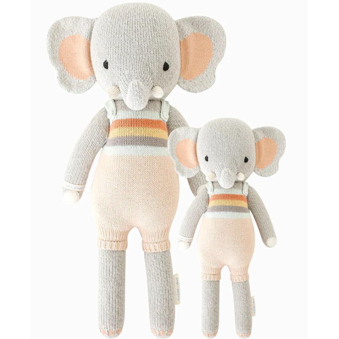 Evan the Elephant | Cuddle + Kind | A gray elephant with peach ears and peach, blue, gray, and yellow overalls. Two sizes pictured, 20" and 13".