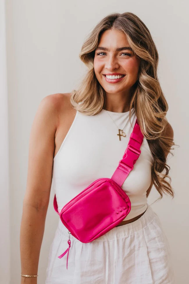 The Nadya Nylon Bum Bag in pink will be your new BFF! This accessory includes a main zipper, a chevron interior, an interior zipper pocket, and an adjustable buckle strap. There is also a zippered pocket on the back of the bag for easy-access to your essentials, and ribbon on each of the exterior zippers. 