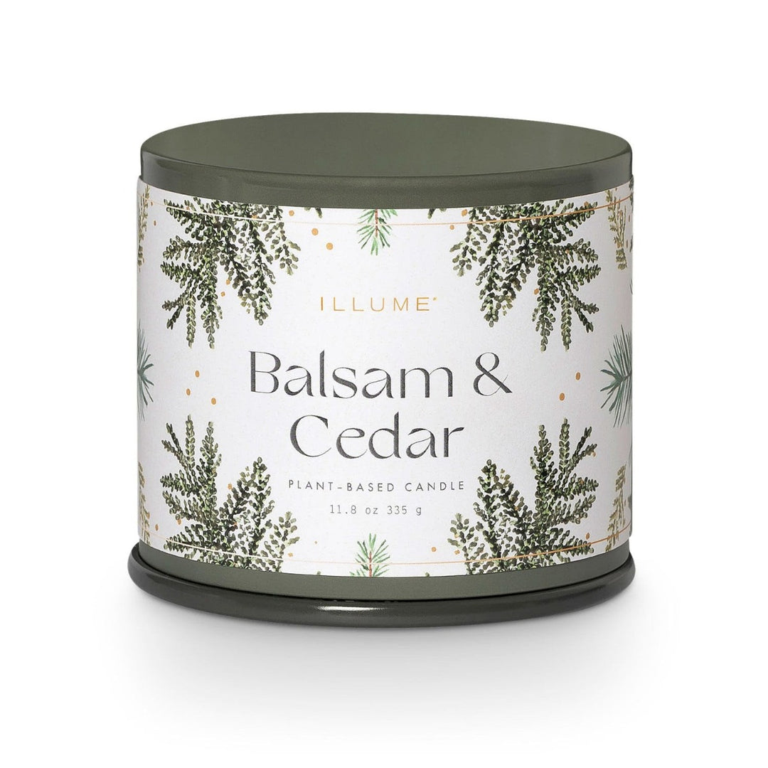 Illume Balsam & Cedar Candle | A green tin candle with a white label decorated with balsam & cedar branches. Label reads "Illume, Balsam & Cedar, plant based candle, 11.8 oz, 335g".