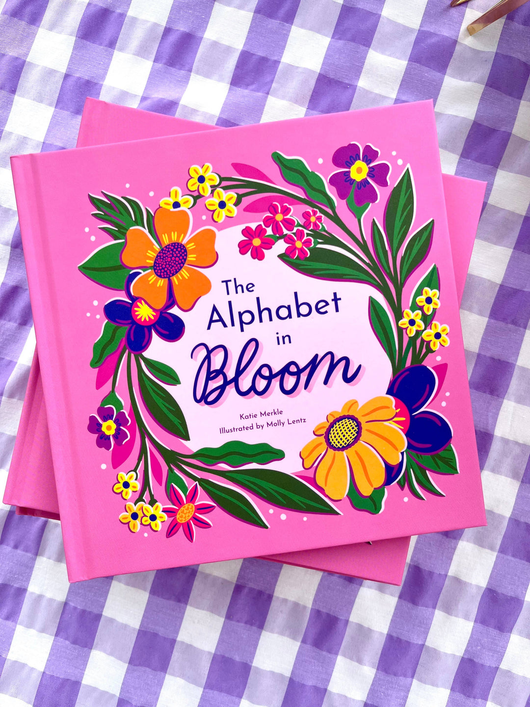 The Alphabet in Bloom is a 7x7 hardcover flower alphabet book with boldly illustrated design.