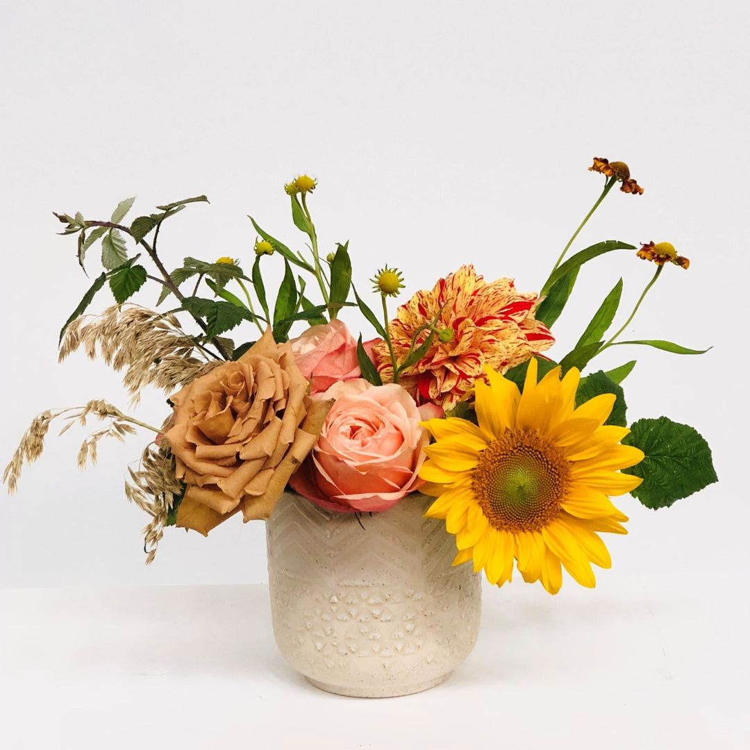 Stacy K Floral | Florist Rochester NY | The Petite Fall Arrangement includes fresh focal blooms in colors like soft pinks, taupe, yellow, orange, and red. Presented in a neutral pot.  Substitutions will be made based on availability.