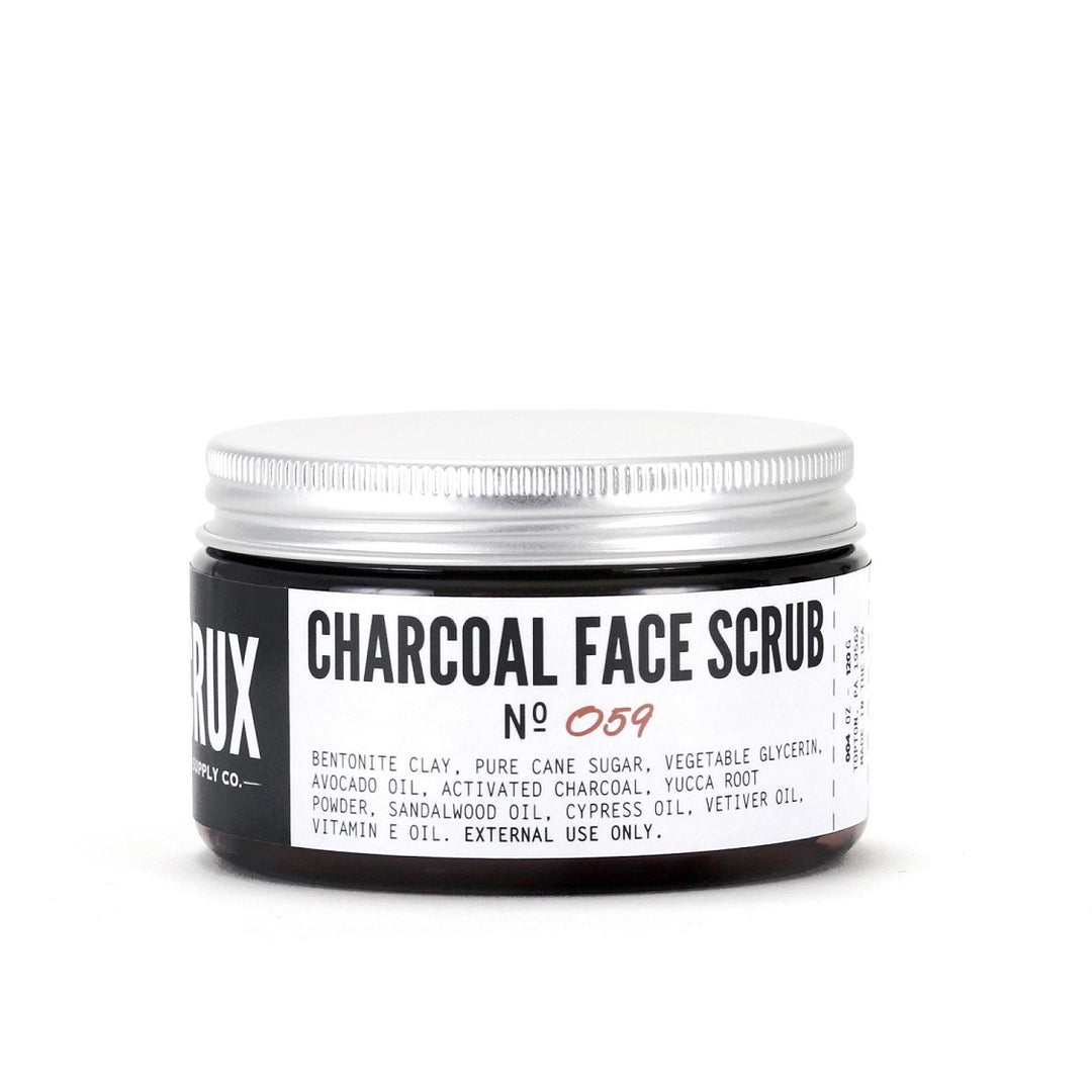Charcoal Face Scrub No 059 | Bentonite clay, pure cane sugar, vegetable glycerin, avocado oil, activated charcoal, yucca root powder, sandalwood oil, cypress oil, vetiver oil, vitamin e oil. External use only. Round container with simple black and white packaging.