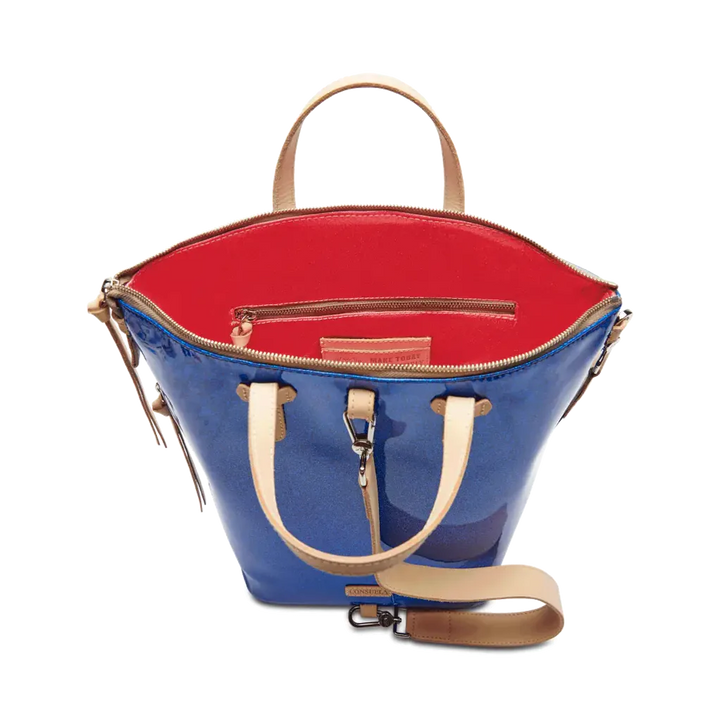 Liv Sling | Consuela | Shows the blue back of the bag and pink interior. Accented with diego leather.