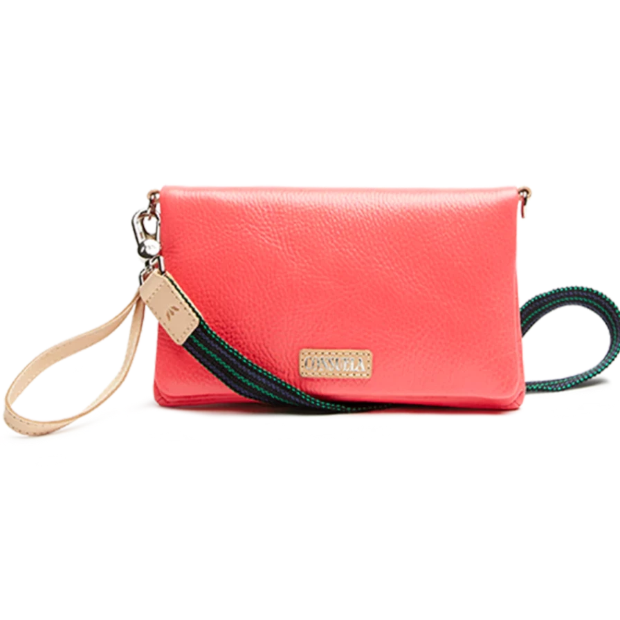 Maron Uptown Crossbody Bag | Consuela | A pink bag with a green and blue strap. Nude color accent leather.