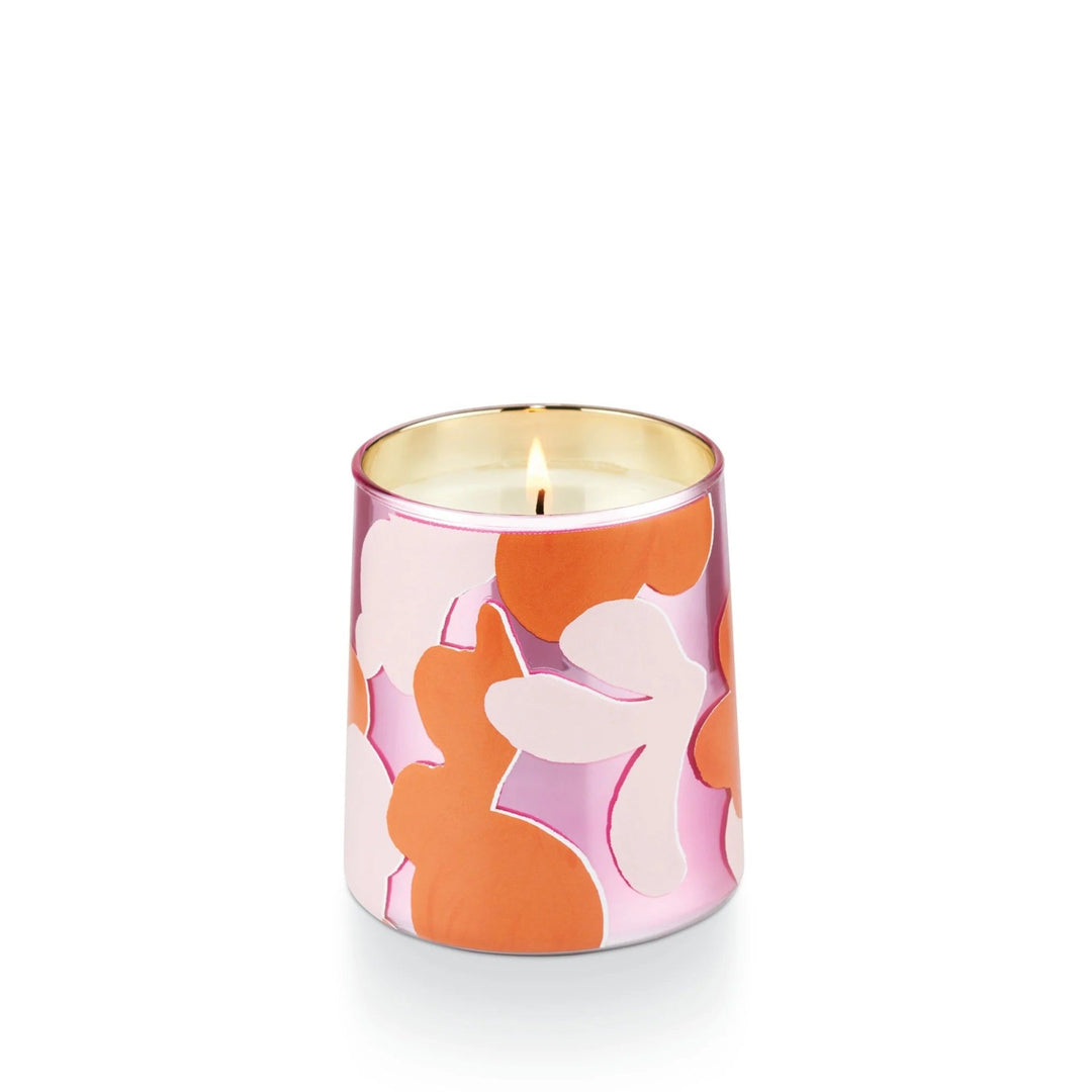 Go Be Lovely Pink Pepper Fruit Candle. Orange and two toned pink candle with a slight taper. Photo taken on a white background.