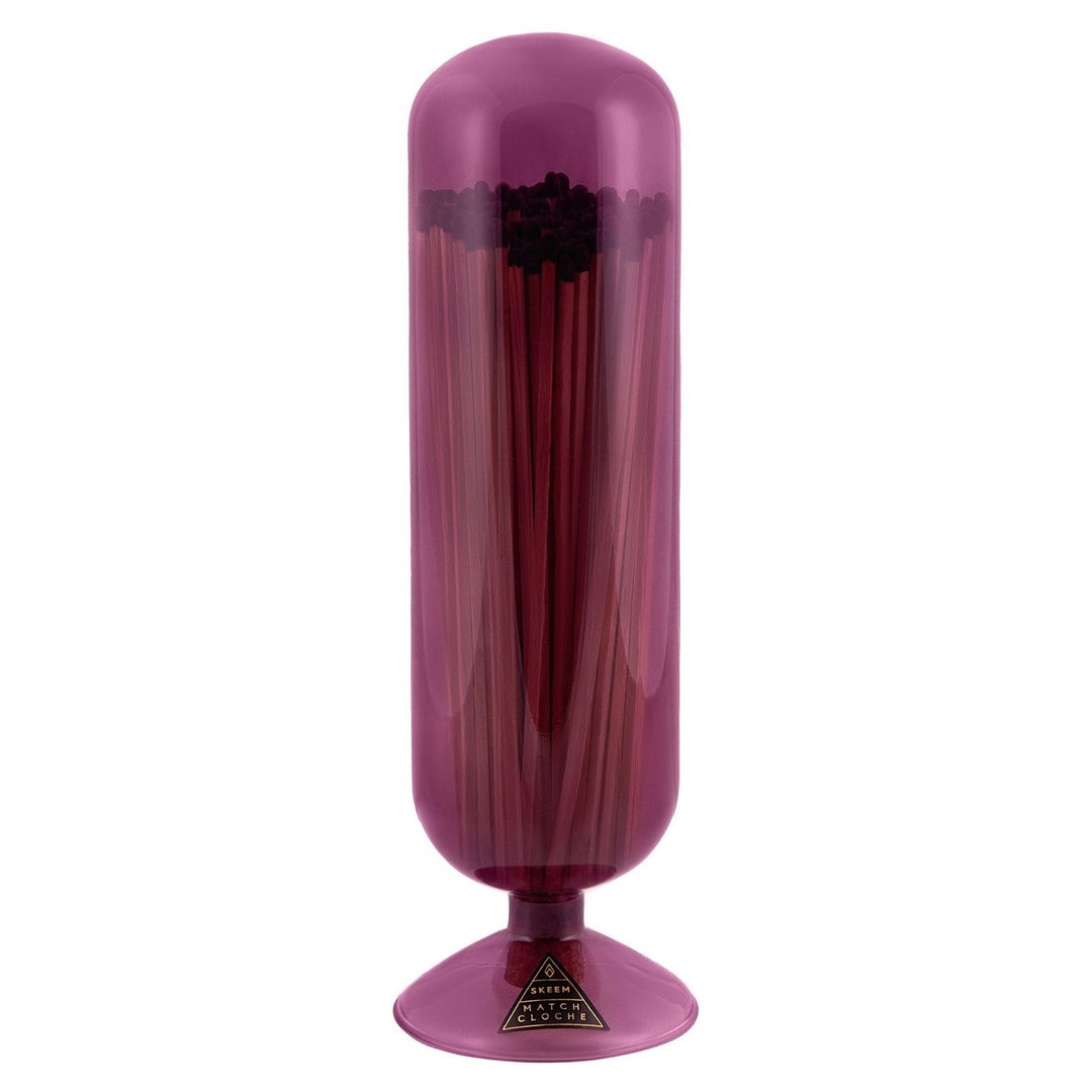 Skeem Mulberry Match Cloche | A Pink/Purple, Glass, Tall Dome cloche. Tinted transparent glass with long stick matches. Photo taken on a white background.