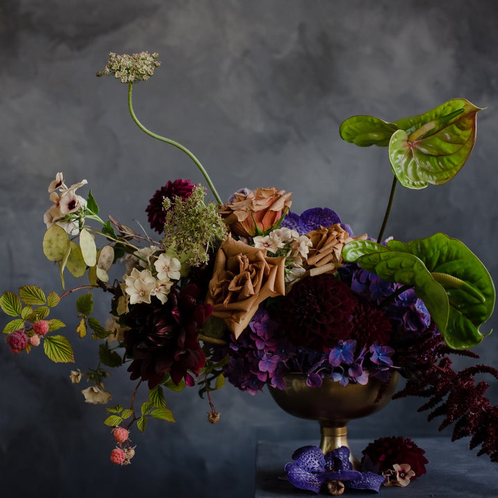 Stacy K Floral | A bespoke style arrangement with rasberry branches, roses, antherium, hydrangea, orchids, and more.