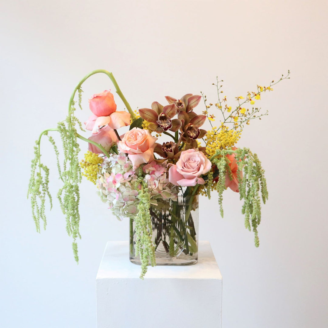 sunbeam vased arrangement of rose, hydrangea and orchis