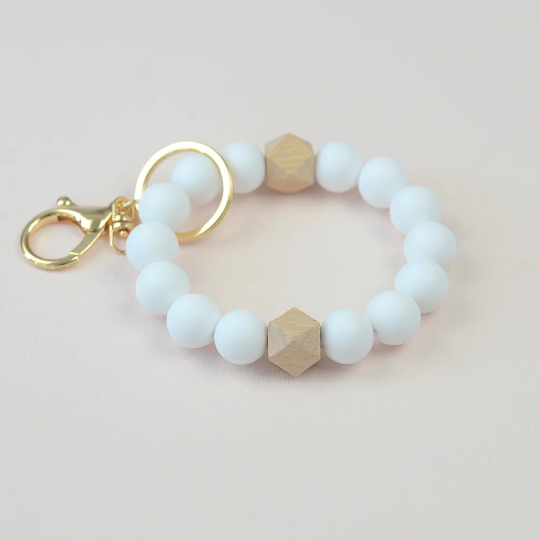 Assorted Beaded Keychains | White silicone beaded keychain with wooden bead accents, and a gold key ring.