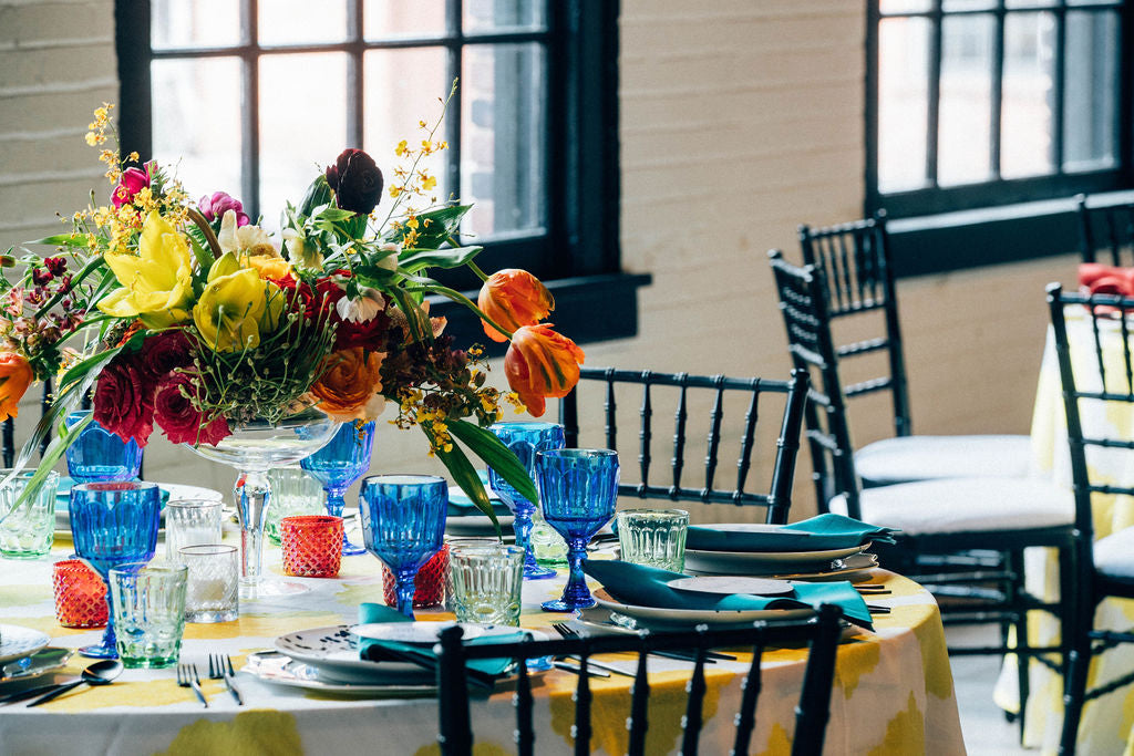 colorful centerpiece with blue drinking glasses 