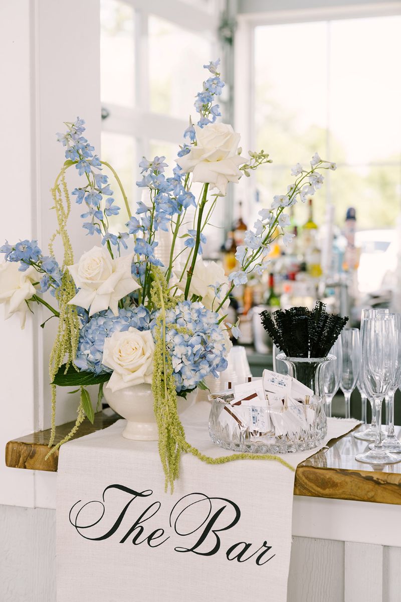 Bar arrangement with white, blue and green florals