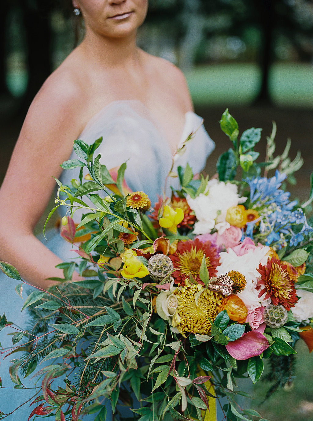 bride holding colorful bouquet