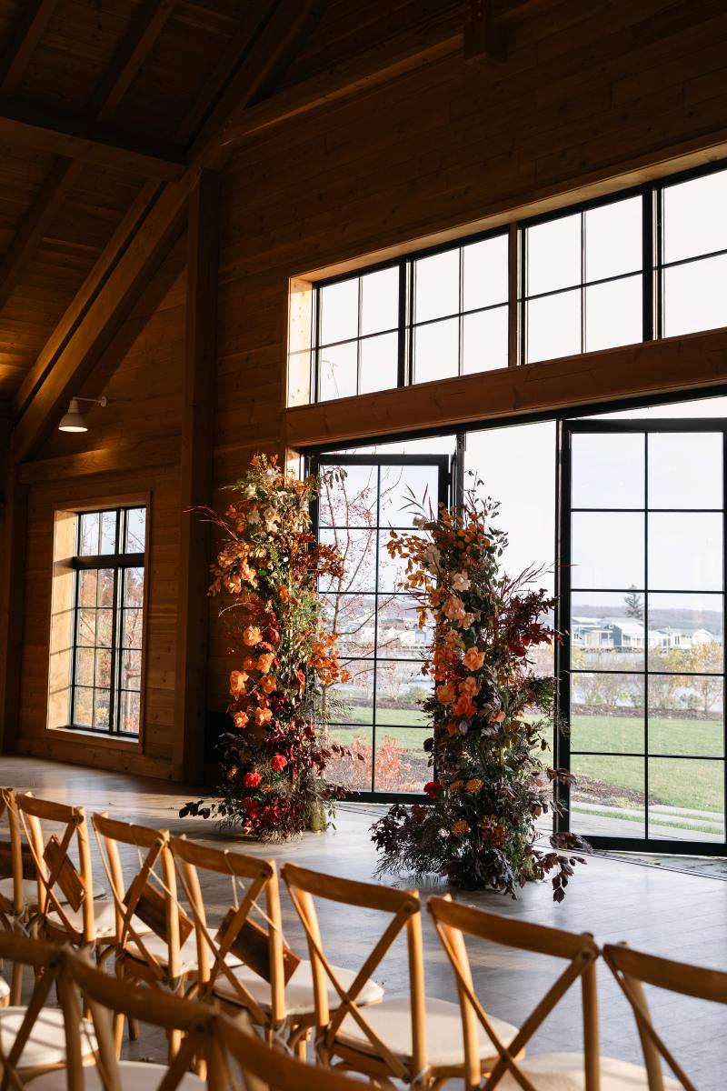 floral arch in a large room with the doors open