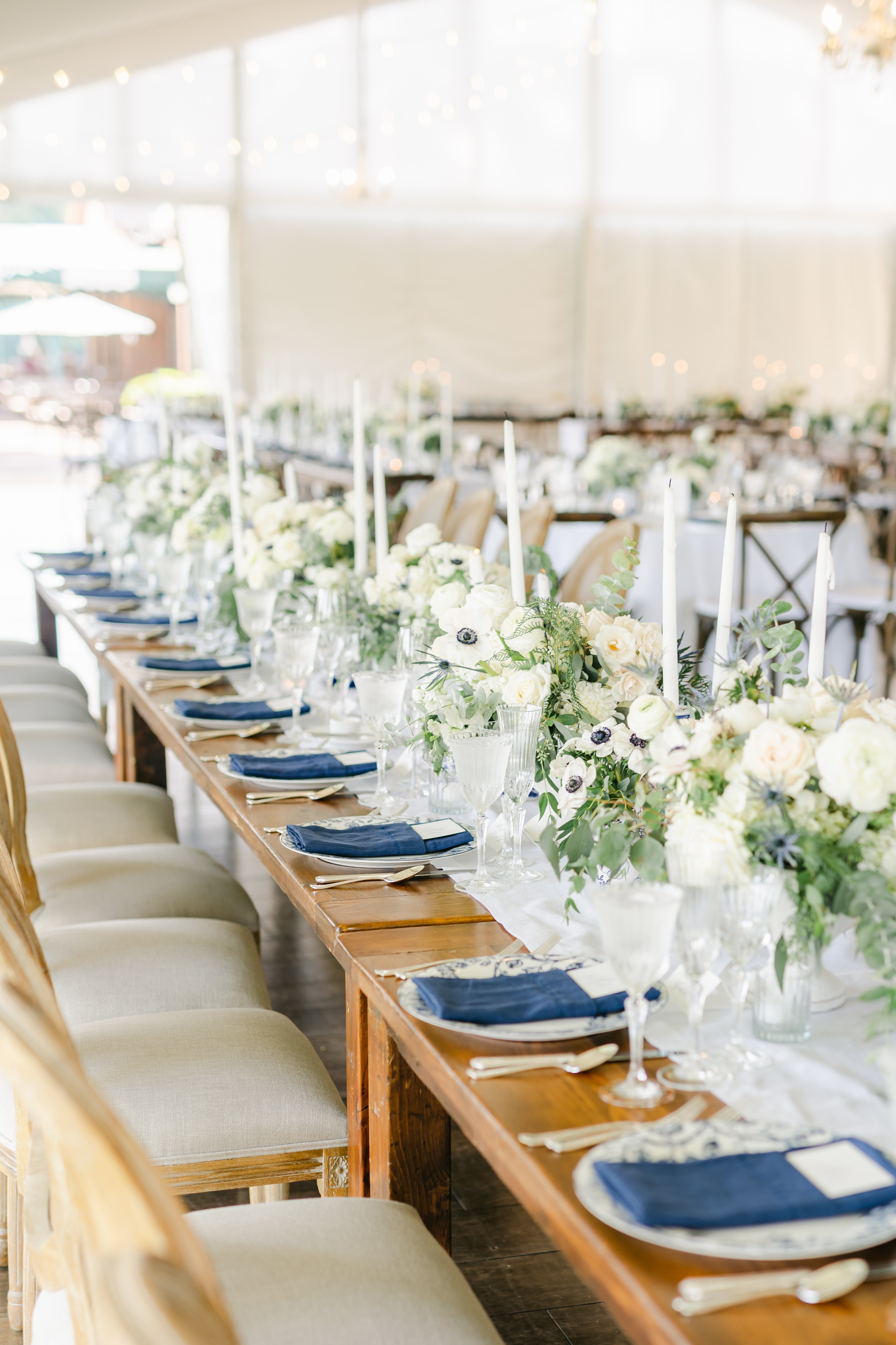 long farm table with white floral centerpieces
