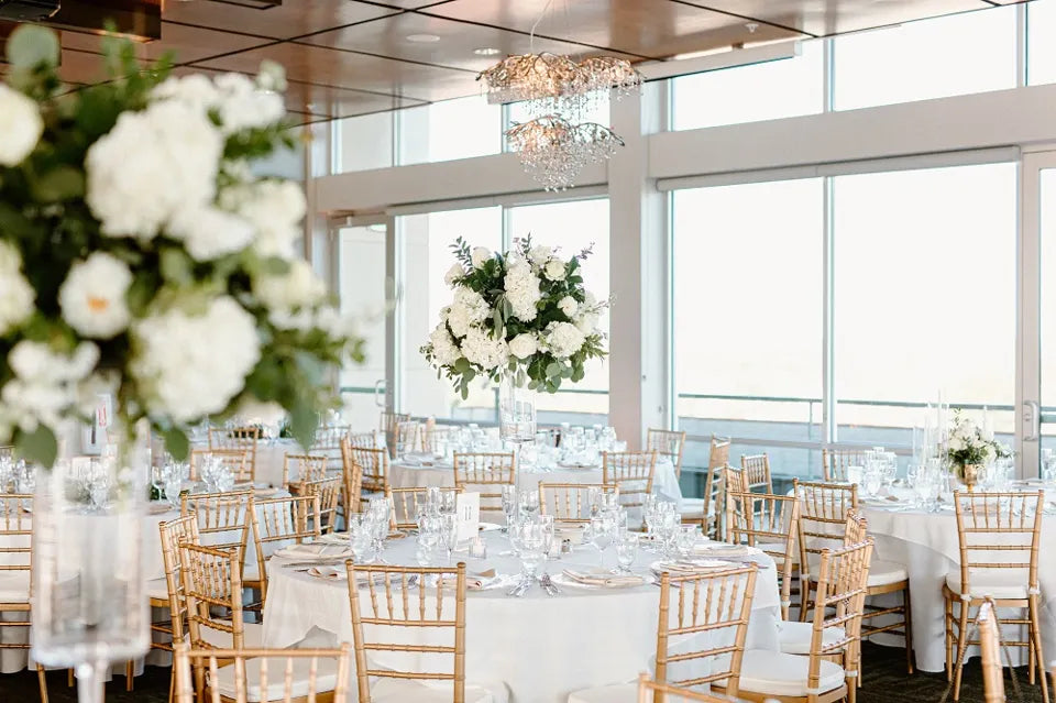 Round guest table with tall white floral centerpiece