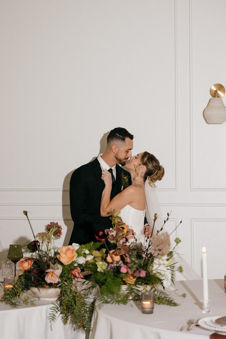 Bride and groom kissing at the Highline with a chocolate floral photo shoot 