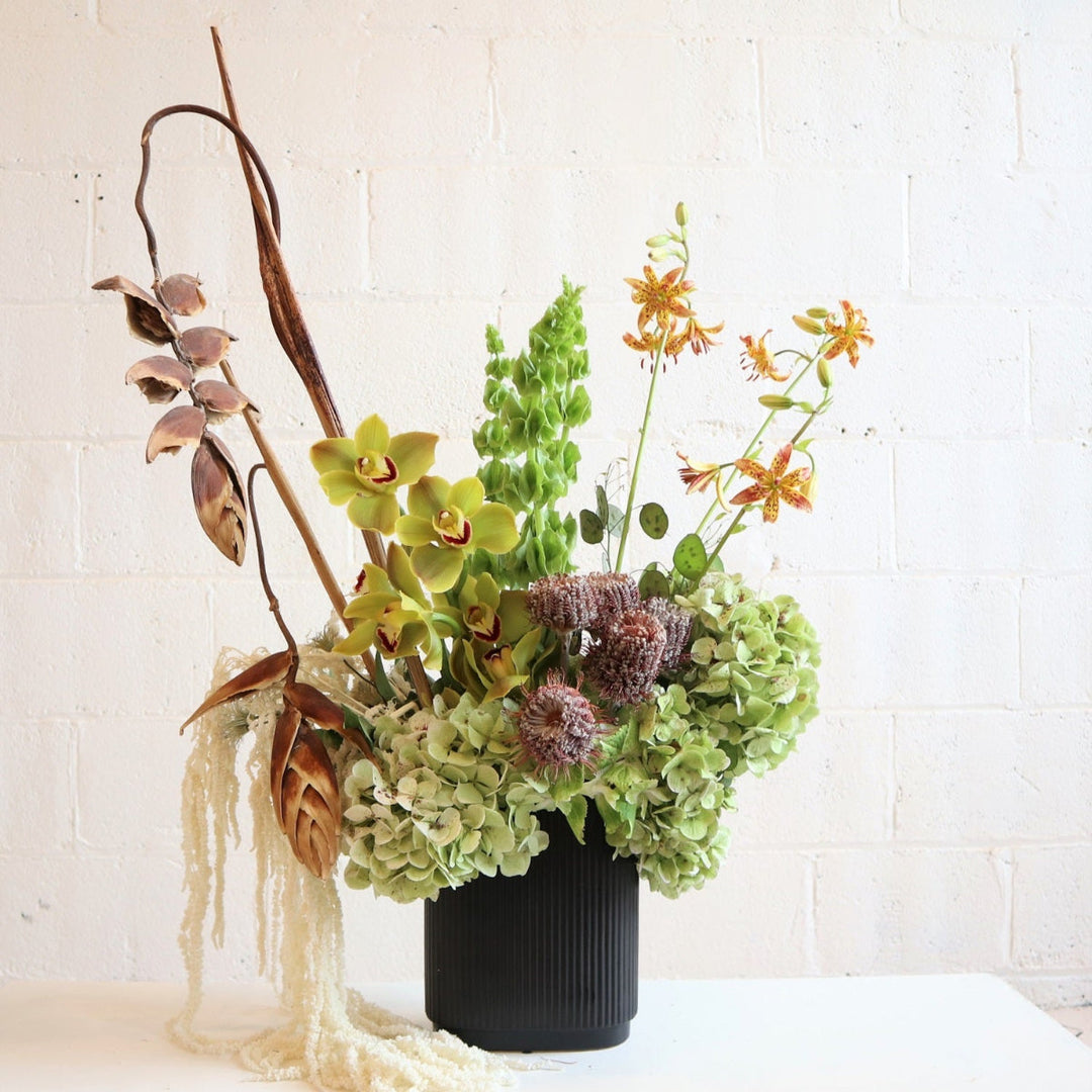 green and brown floral arrangement on a white backround