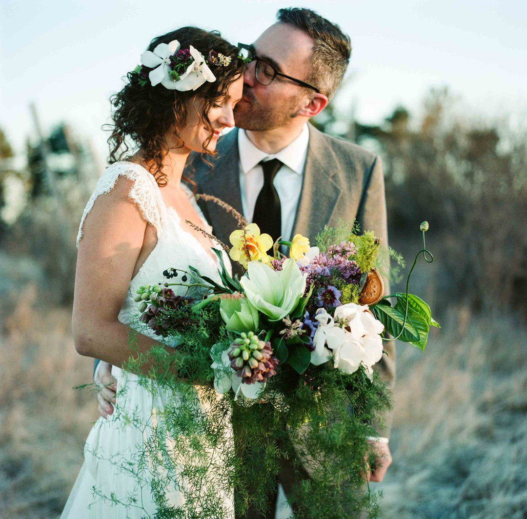 groom kissing bride's forehead 