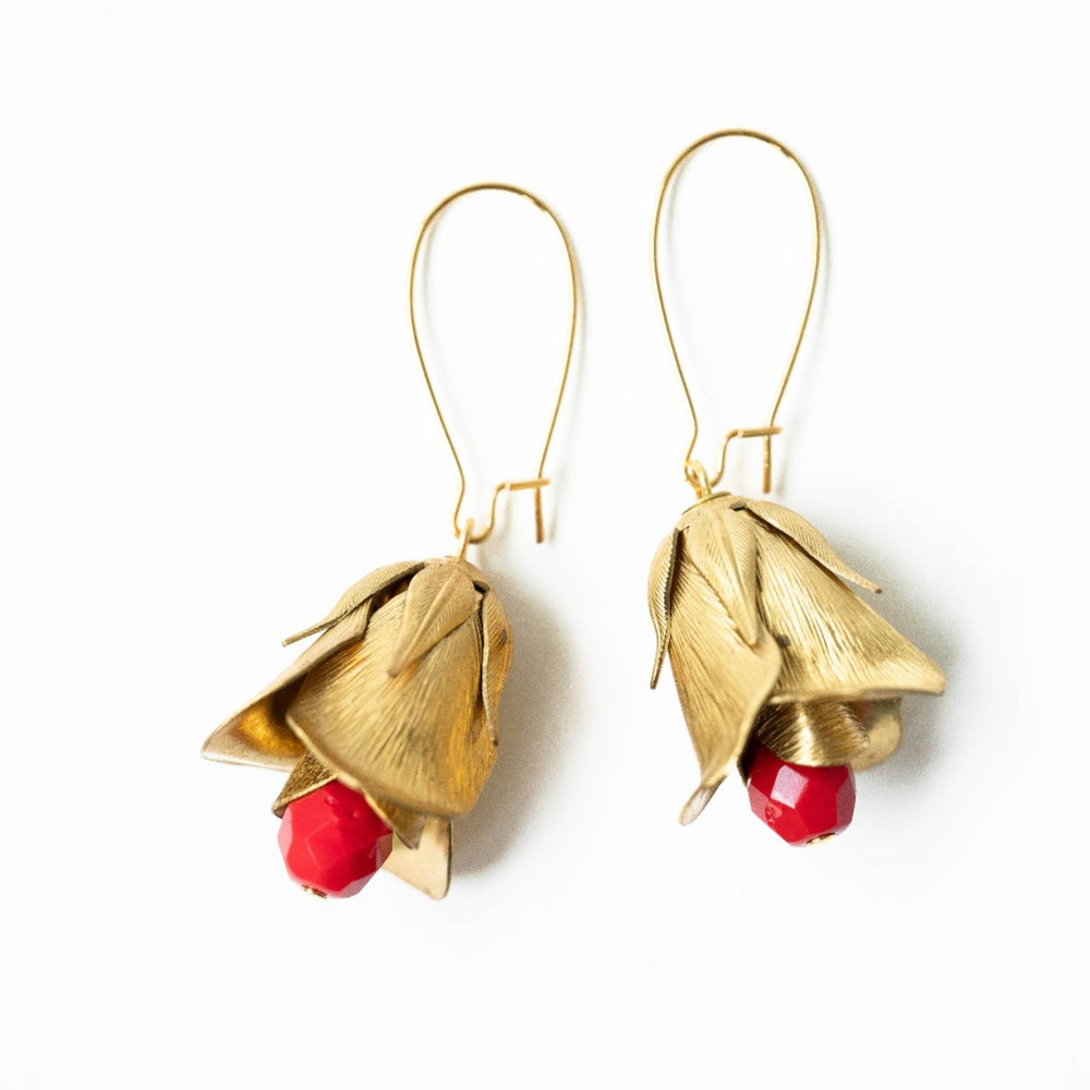 Nest Pretty Things | Red Flower Bud Hanging Earrings | Close up on the brass flower earrings with a red beaded center.