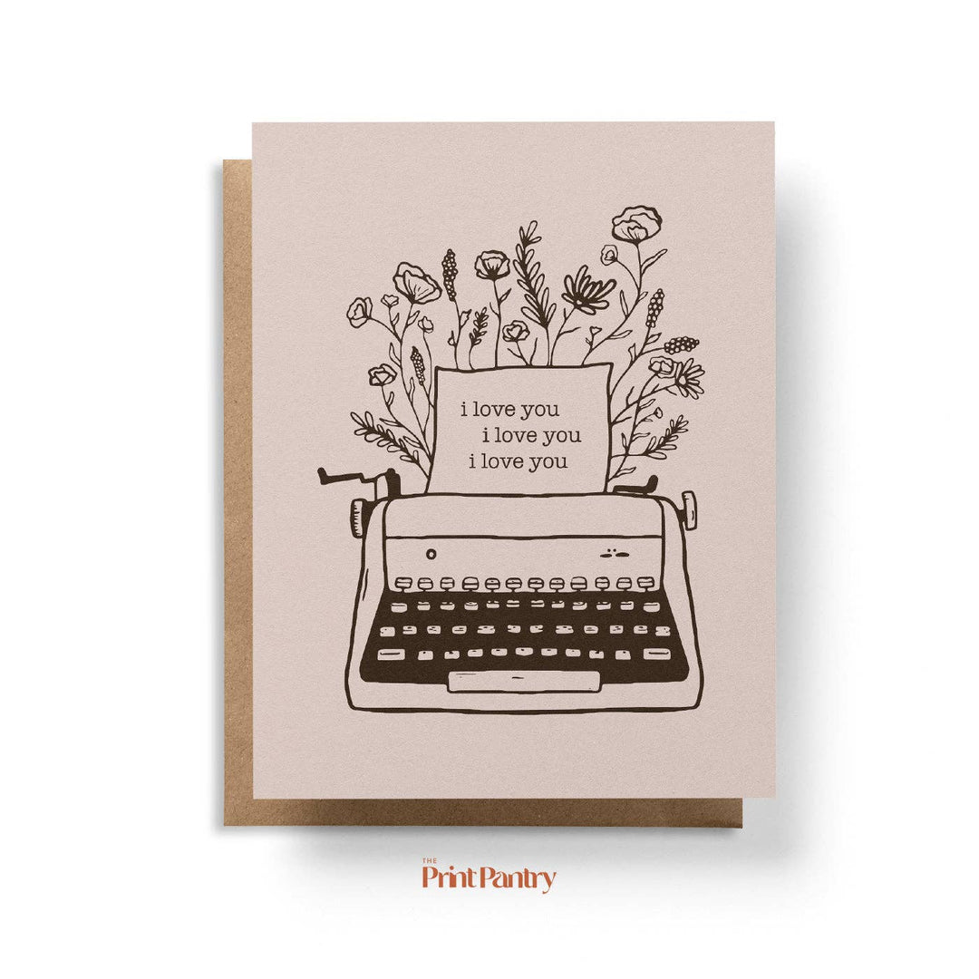 Greeting card with typewriter and floral design on a beige background, featuring the brand 'Print Pantry'.