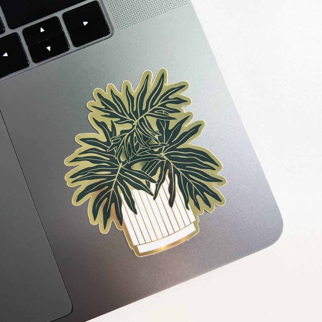 Split-Leaf Philodendron Plant Sticker | A green, gold and white sticker on a silver computer.