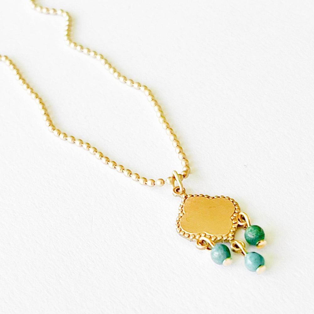 Nest Pretty Things | Turquoise Pendant Necklace | Close up on the gold pendant and turquoise beads.