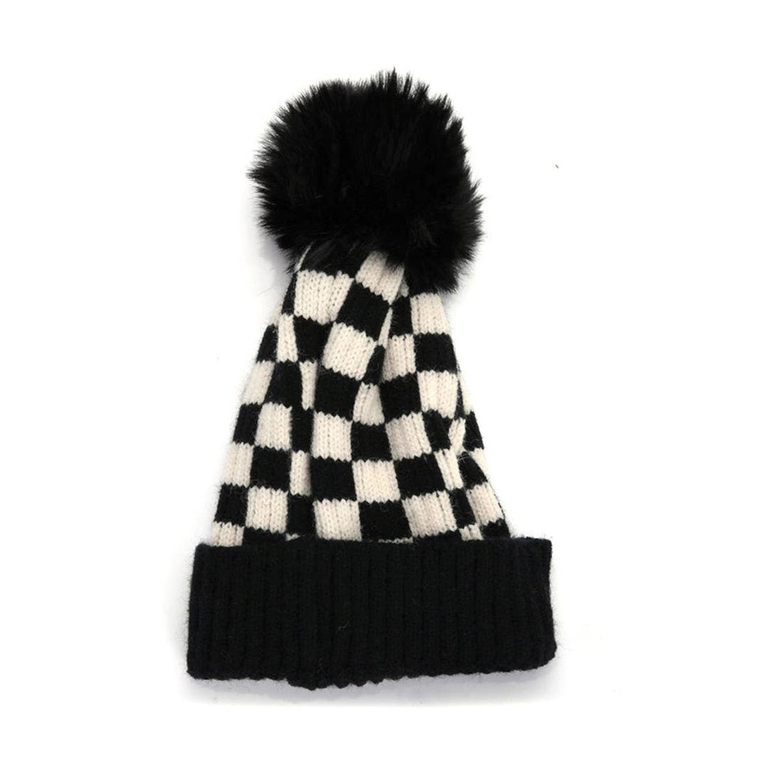 Accity | A knit black checkered beanie with a fuzzy pom pom.